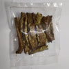 A clear plastic bag containing several dried, brownish strips or pieces of sandagi Mirchi, photographed on a plain light background.