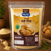 A stand-up pouch of Shreeshankar Food's Malathpatti Vade Pith (fried dough snacks) in a transparent package showing the light beige powder inside. The packaging features a yellow and brown label with Hindi text and an image of golden-brown fried snacks.