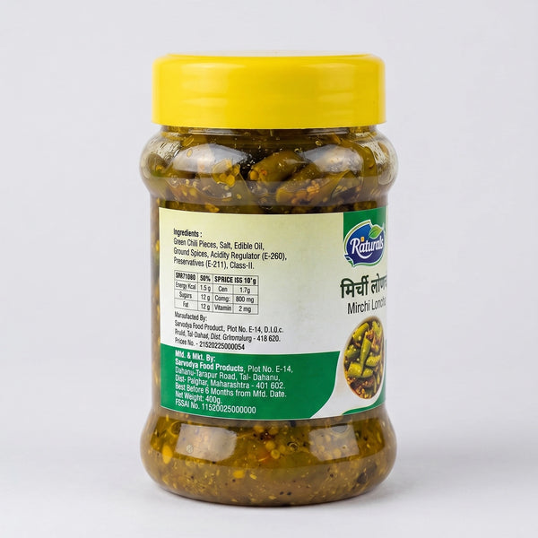 A jar of Sindhuswad Foods  Mirchi spice pickle by Naturals, featuring a bright yellow lid and a green and white label, set against a plain light gray background.