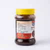 A jar of  Sindhuswad Foods Sweet Lemon Spice paste on a clean white background. The product is in a clear plastic jar showing the dark brown paste inside, topped with a bright yellow cap, and has a white and red label.